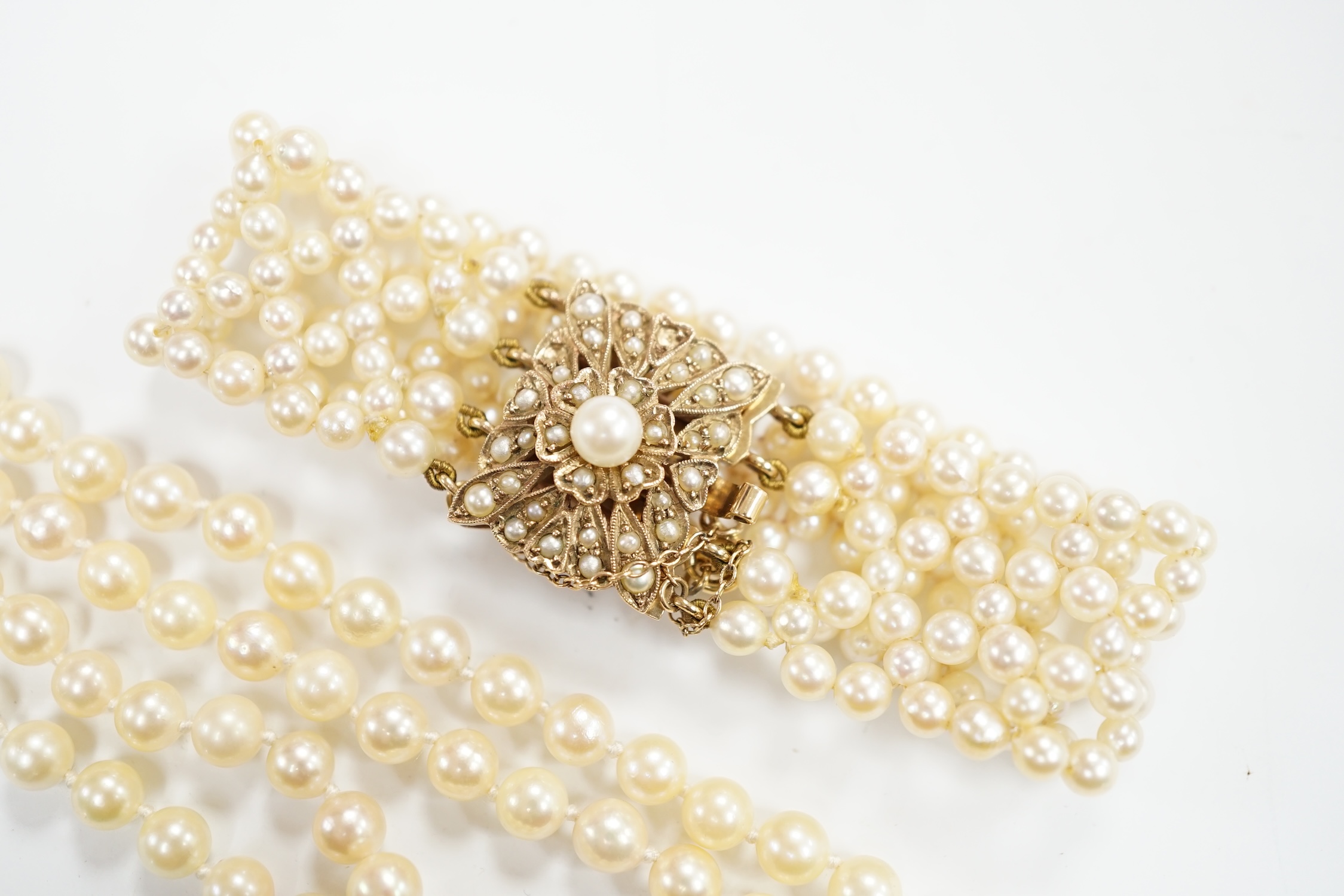 A cultured pearl cluster set bracelet, with seed pearl cluster set 9ct clasp, 16cm, and a similar double row choker necklace, with 9ct clasp, 38cm.